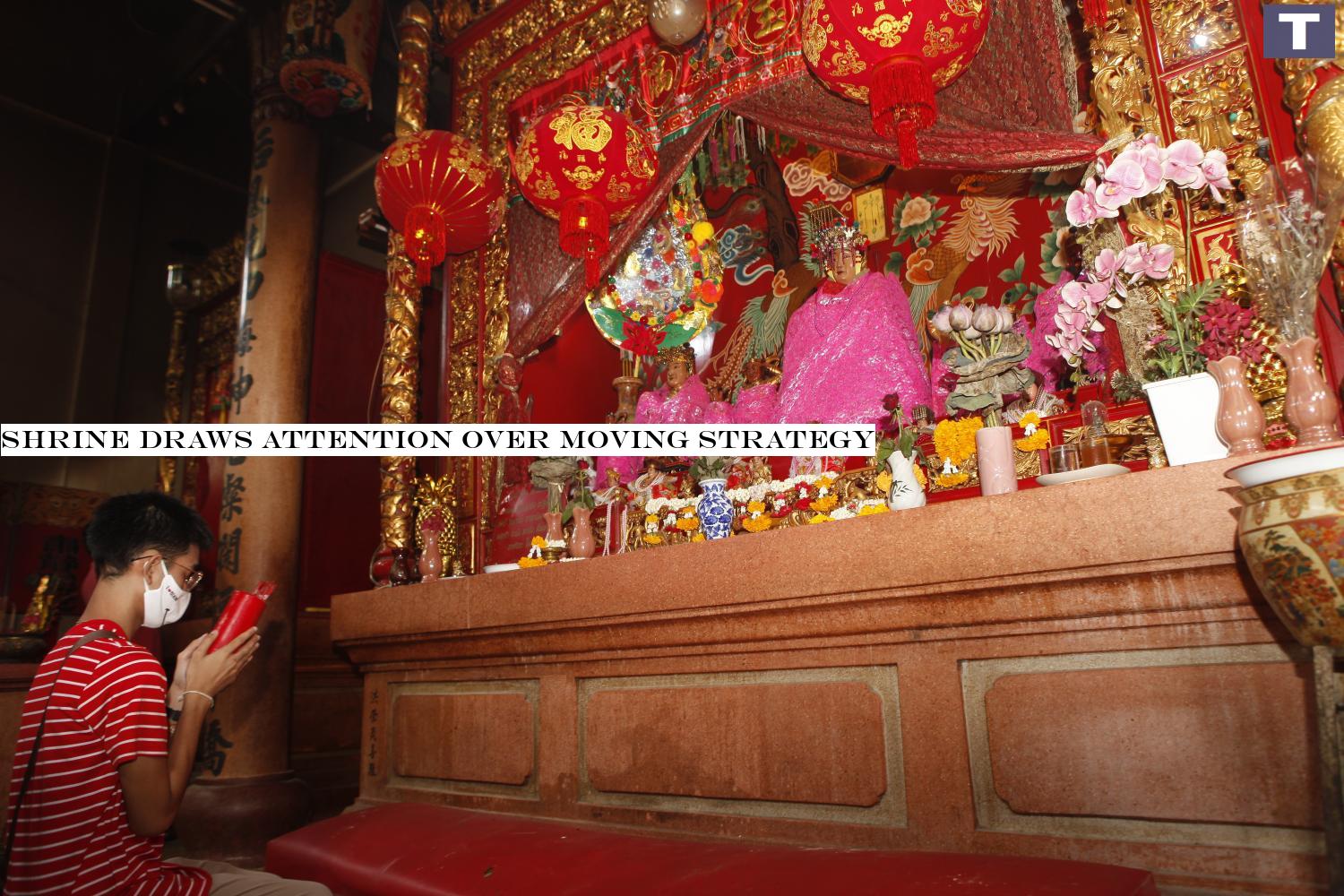 Unshaken belief: A youth offers prayers to the Thapthim Goddess Shrine in Saphan Lueang. People fear the shrine will be relocated to make way for a Chulalongkorn University building in the same location. Shrine draws attention over relocation plan