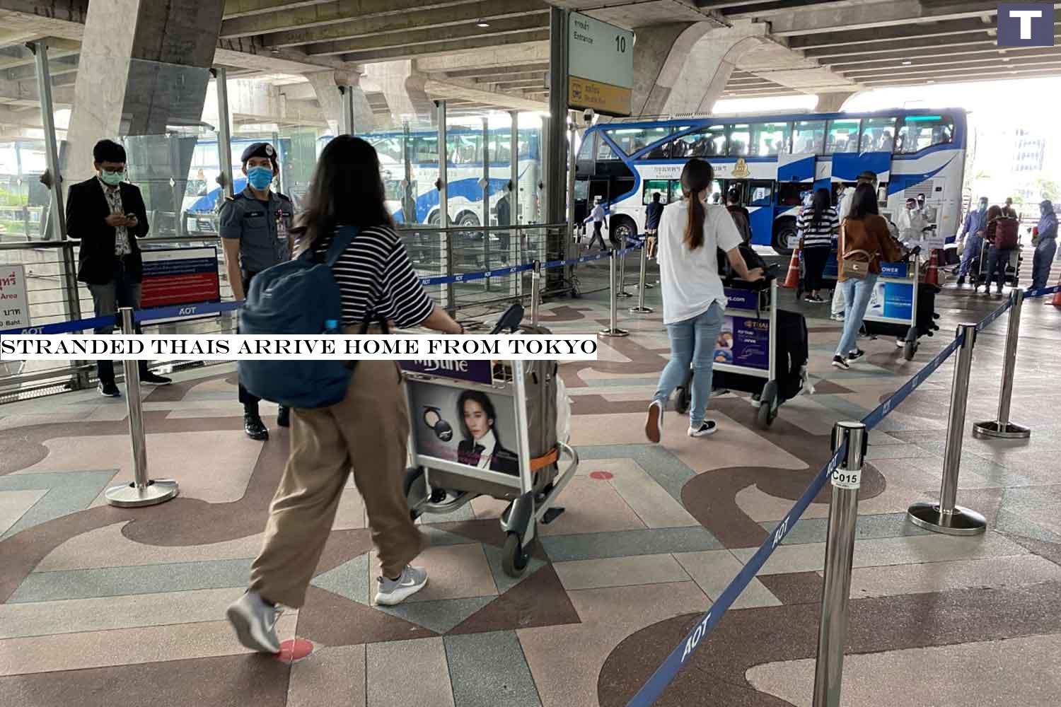 Returnees board buses at Suvarnabhumi airport, heading for 14-day quarantine, after arriving home from Japan on Tuesday. (Photo: Sutthiwit Chayutworakan) Stranded Thais arrive home from Tokyo