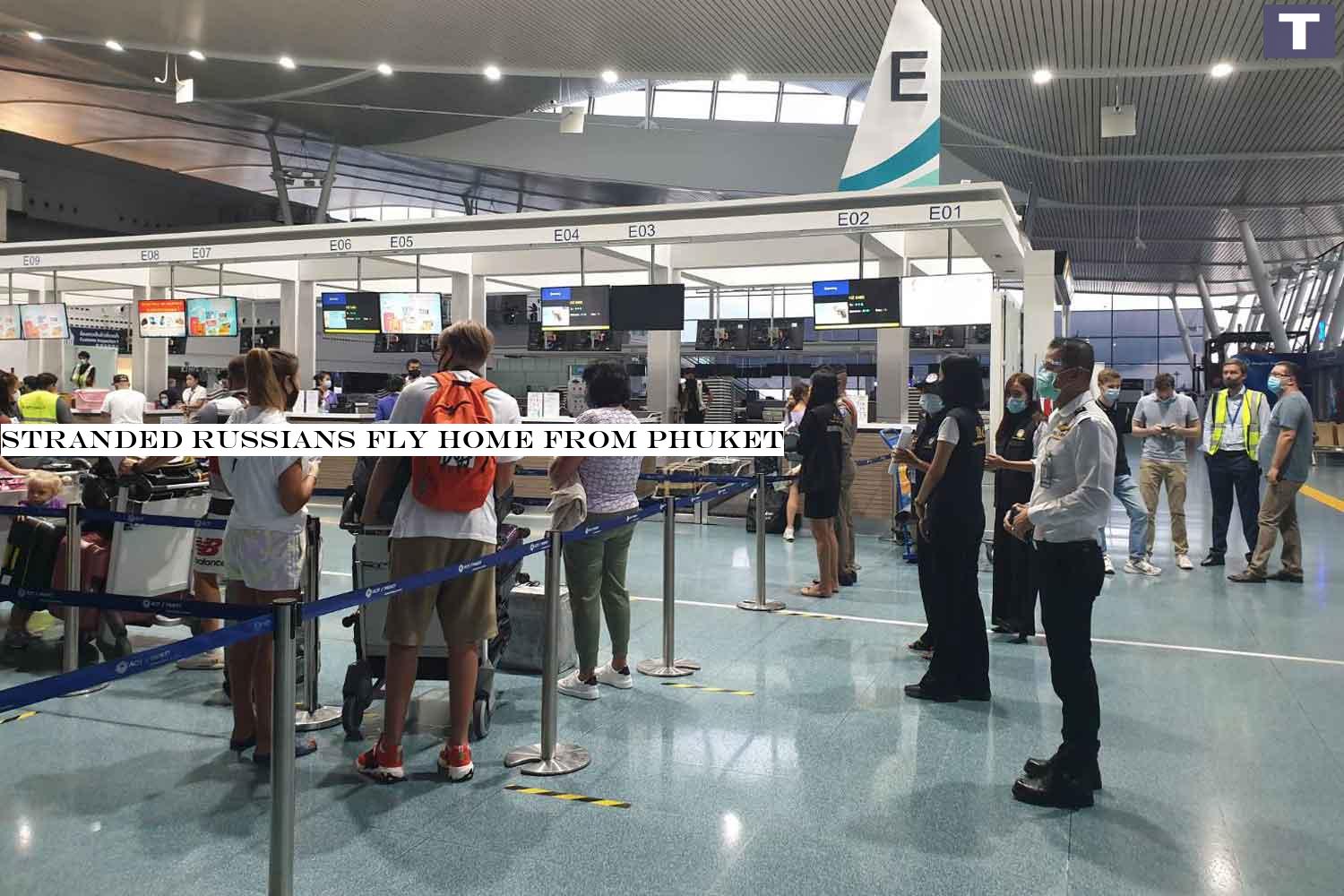 Russian tourists go through immigration at Phuket international airport before flying home on Tuesday night, after being stranded in Thailand by the Covid-19 outbreak. (Photo: Achadtaya Chuenniran) Stranded Russians fly home from Phuket