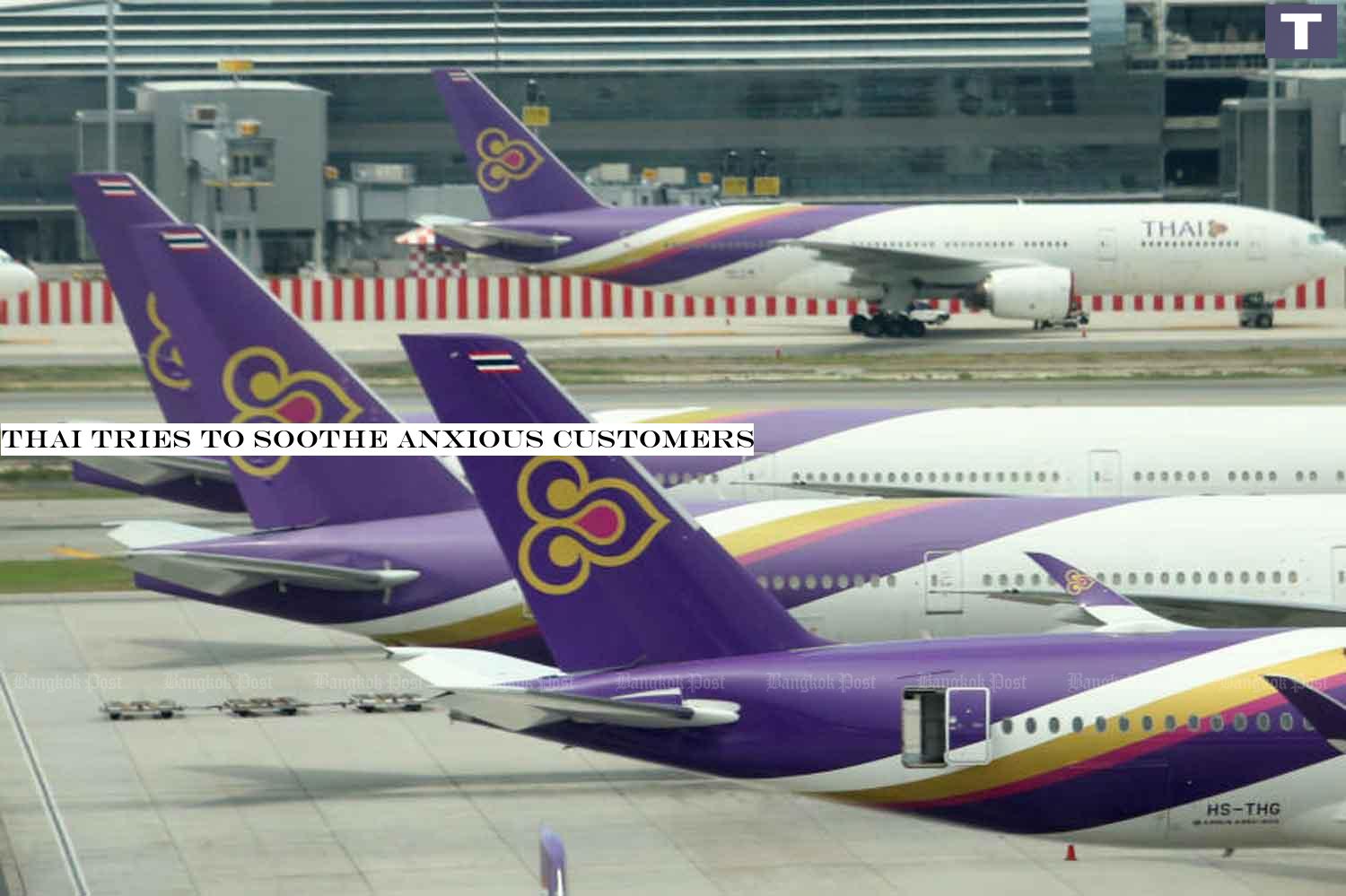 Thai Airways International airplanes sit on the tarmac at Suvarnabhumi airport. THAI tries to soothe anxious customers