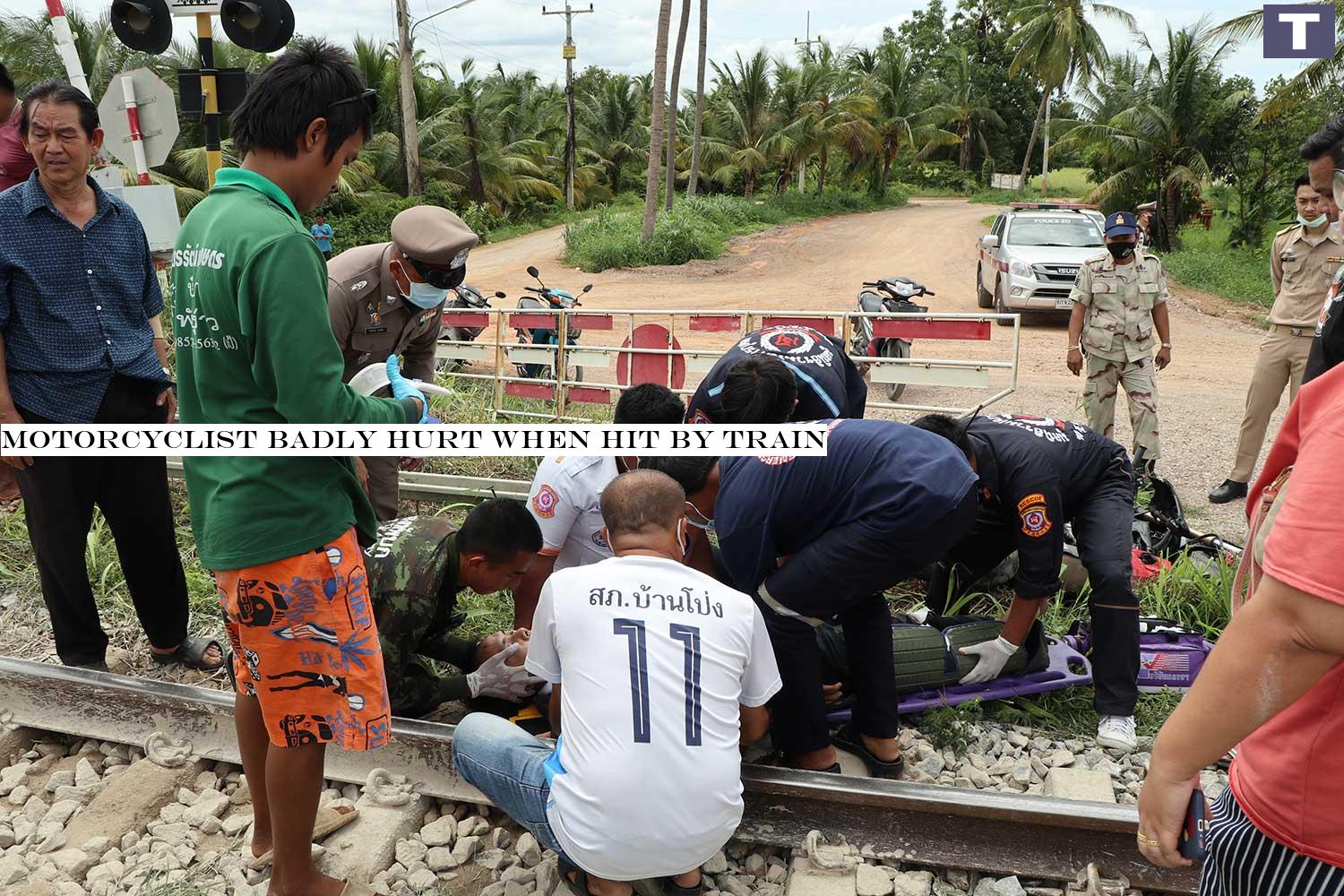 A motorcyclist suffers broken legs after he rode through a railway crossing and was hit by a locomotive in Ban Phong district, Ratchaburi on Friday afternoon. (Photo: Saichol Srinuanchan) Motorcyclist badly hurt when hit by train