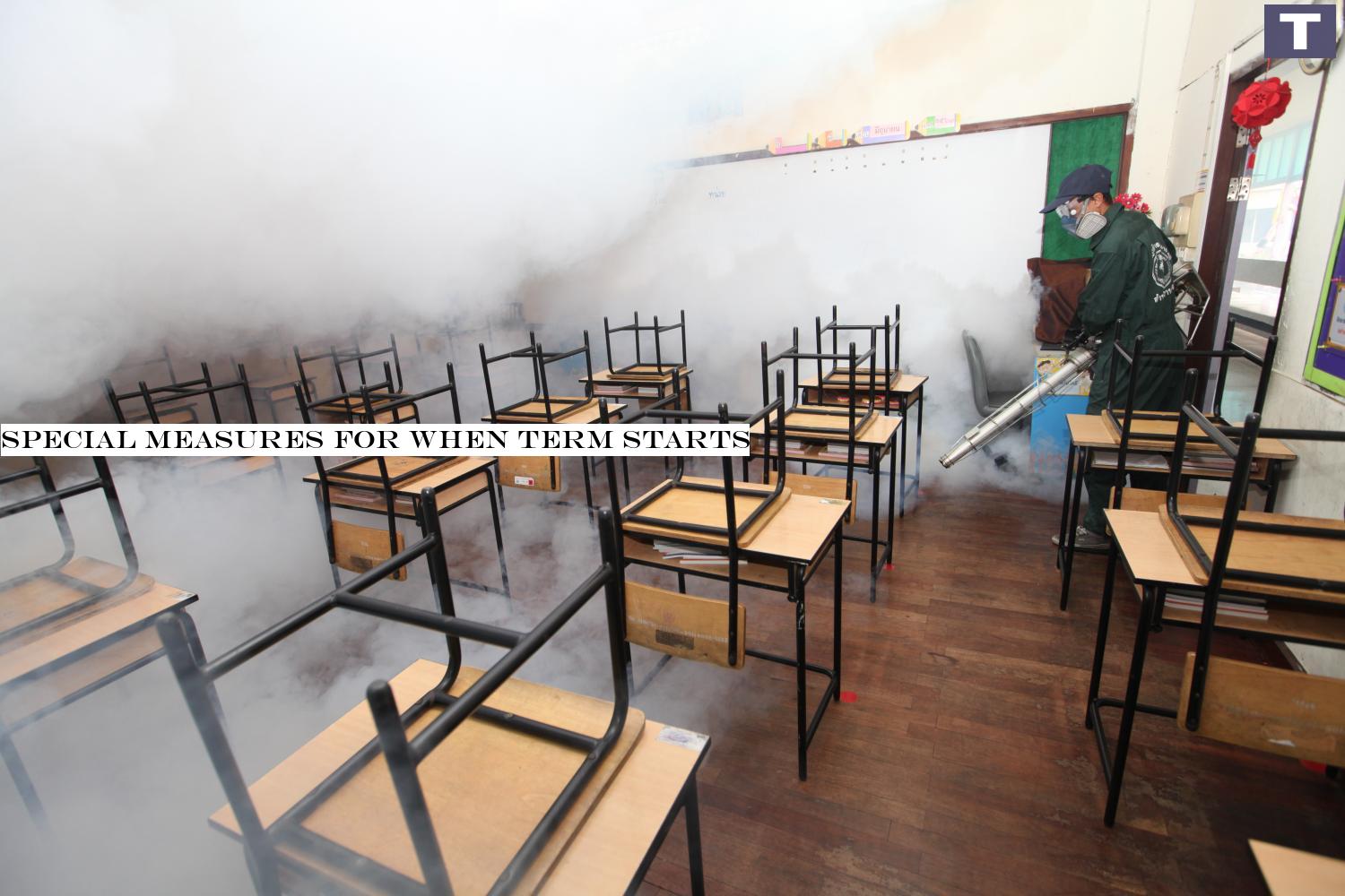 A Bang Rak district official on Monday sprays mosquito repellent in a classroom at Wat Hua Lamphong School to prepare for the new term that will begin on July 1. (Photo by Arnun Chonmahatrakool) Special measures for when term starts