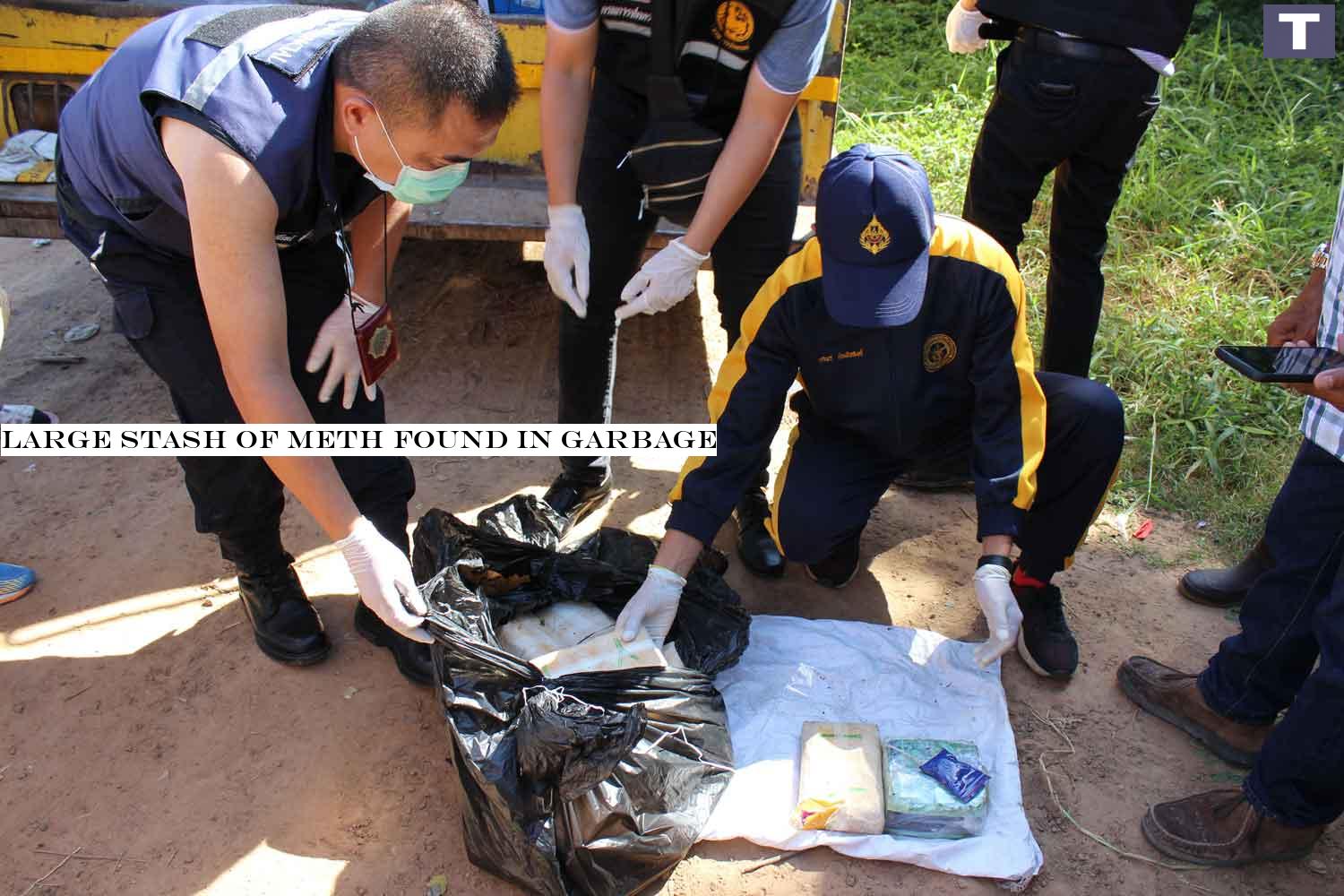 Police examine the black bag found by a garbage truck crew in Muang district of Kalasin on Tuesday morning. It contained 78,000 meth pills and 2kg of crystal meth. (Photo: Yongyuth Phuphuangpet) Large stash of meth found in garbage