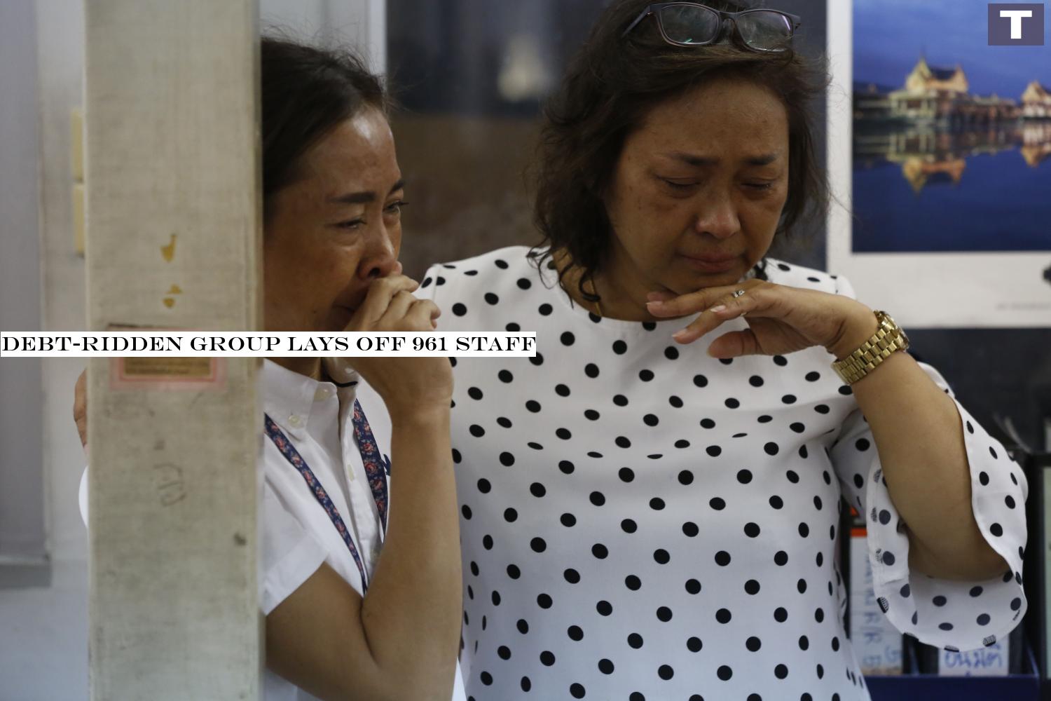 Staff of the Business Organisation of the Office of the Welfare Promotion Commission for Teachers and Educational Personnel cry after learning they have been laid off.â-#128;-#137; photos by Pornprom Satrabhaya Debt-ridden group lays off 961 staff