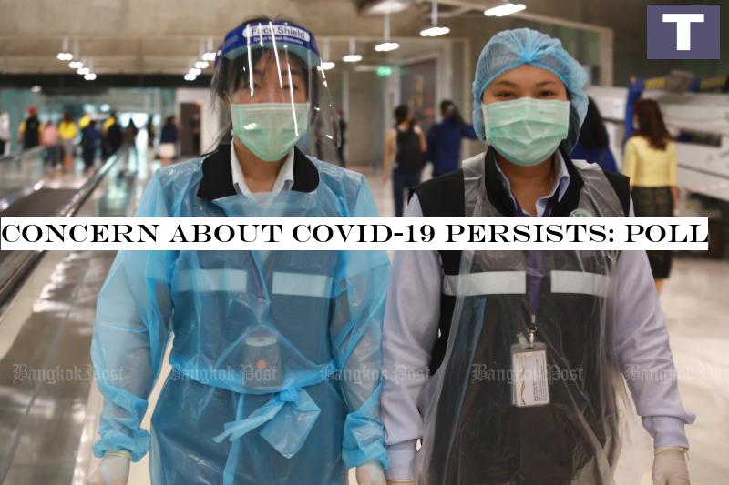 Quarantine officials protect themselves from Covid-19 as they walk at Suvarnabhumi airport on Friday. (Photo by Somchai Poomlard) Concern about Covid-19 persists: Poll