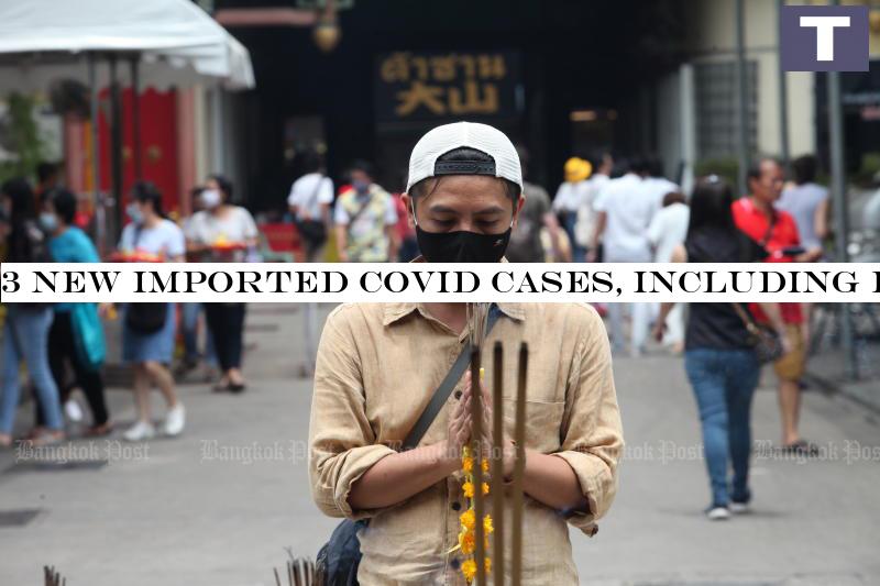 A devotee prays before a Buddha statue inside Wat Mangkorn Kammalawas, where visitors are required to wear masks, in Bangkok on Sunday. (Photo by Apichart Jinakul) 3 new imported Covid cases, including foreigner, Monday