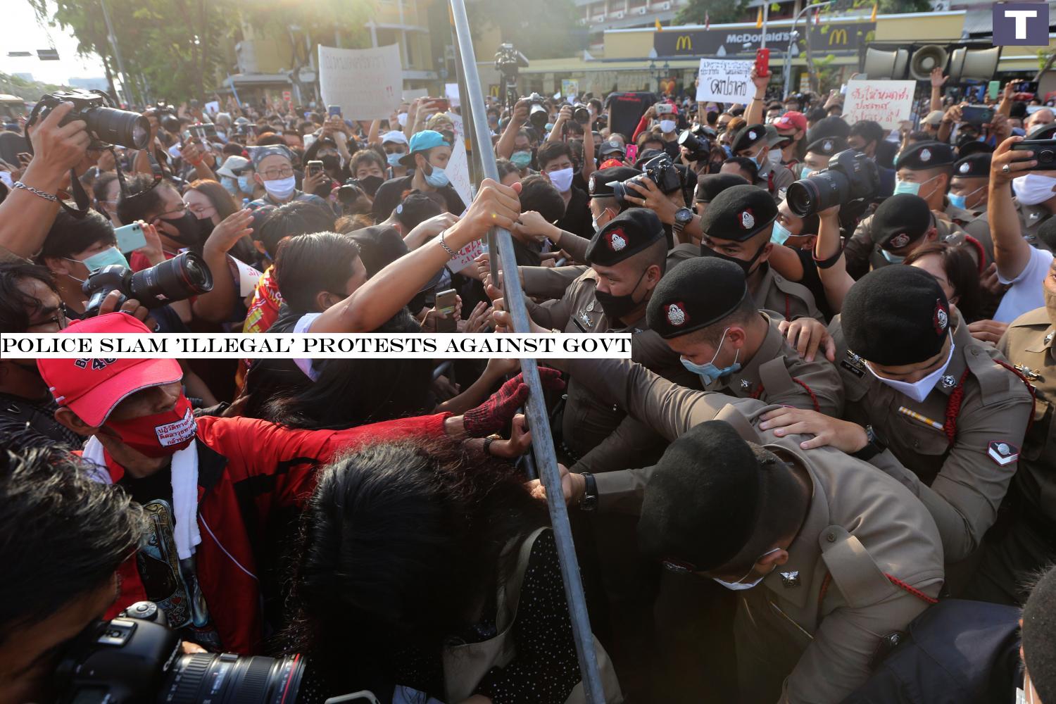 Battle of wills: Protesters from the Student Union of Thailand and the Free Youth group attempt to break past security barricades around the Democracy Monument as police officers try to stop them from demonstrating. Police slam 'illegal' protests against govt