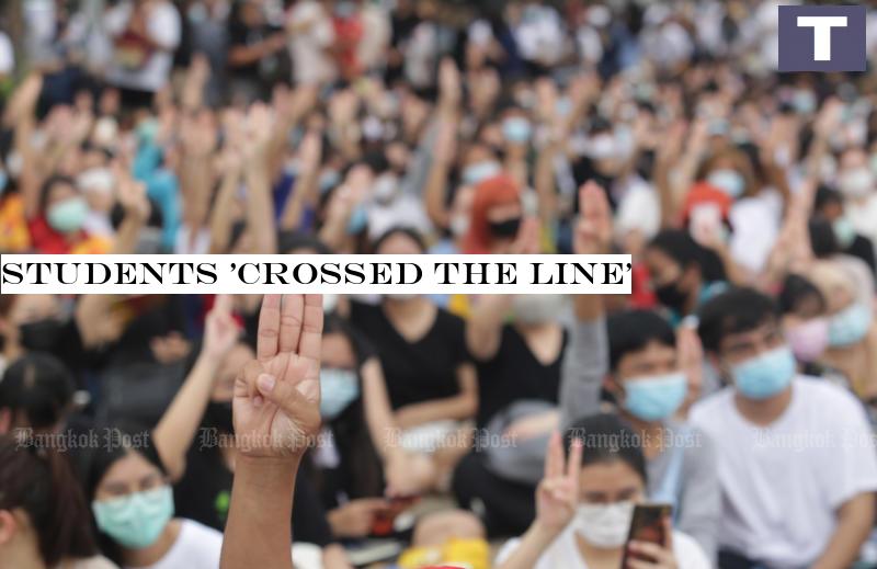 Young anti-government protesters flash the three-finger anti-coup sign during a rally at Thammasat University's Rangsit campus on Monday. (Photo by Apichit Jinakul) Students 'crossed the line'