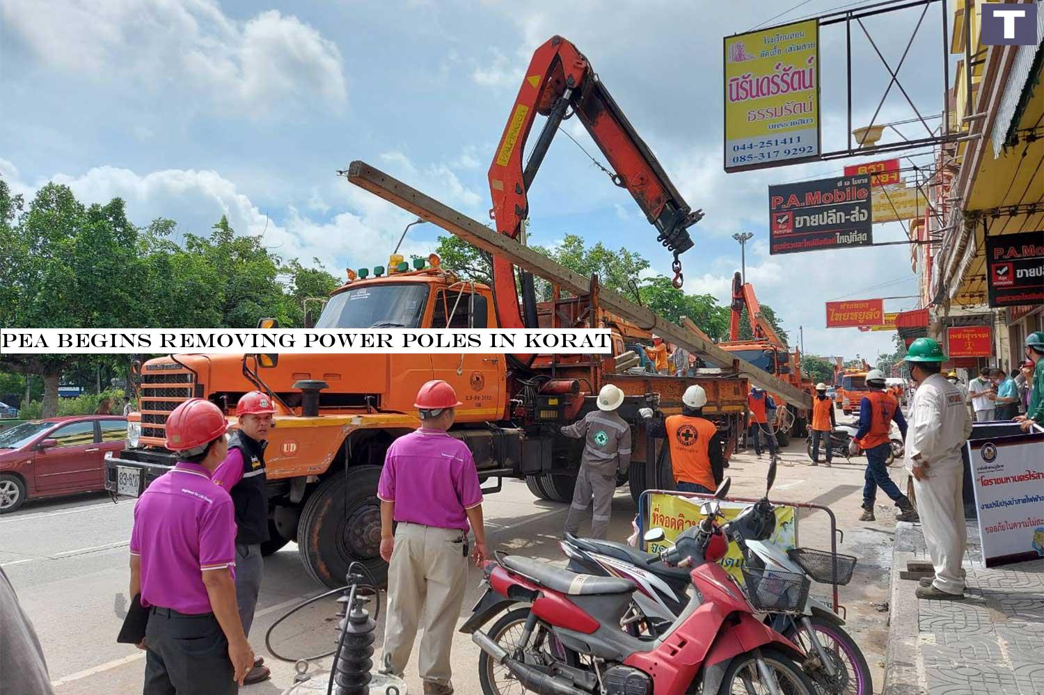 A concrete power pole is lifted onto a truck after Provincial Electricity Authority workers finish moving electrical wires and cables underground in parts of Nakhon Ratchasima on Saturday. (Photo by Prasit Tangprasert) PEA begins removing power poles in Korat