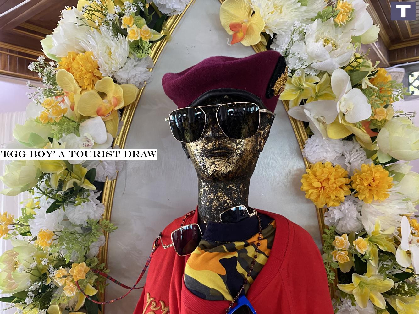 The statue of Ai Khai wearing black glasses and military camouflage uniform â-#128;-#148; which are among popular offerings presented by the faithful. 'Egg boy' a tourist draw