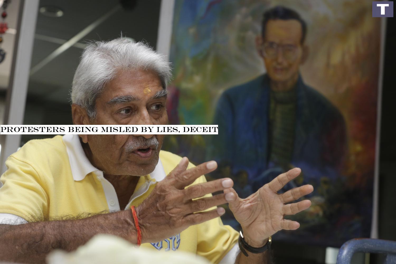 Satish Sehgal at a condominium in Bangkok's Saladaeng Soi 2 with a painting of His Majesty King Bhumibol Adulyadej The Great in the background.â-#128;-#137;(Photo by Pornprom Satrabhaya) Protesters being misled by lies, deceit