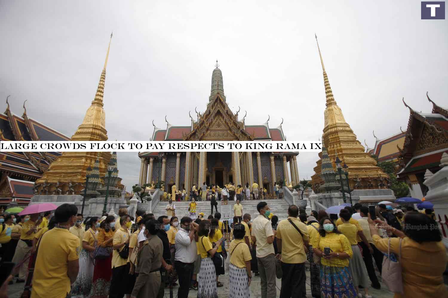 Yellow-clad people line up on Tuesday to pay homage before the statues of the nine late kings at Prasat Phra Thep Bidon (Royal Pantheon) inside Wat Phra Kaeo in Bangkok in commemoration of the passing of His Majesty King Bhumibol Adulyadej The Great.â-#128;-#137;(Photo by Nutthawat Wicheanbut) Large crowds flock to pay respects to King Rama IX