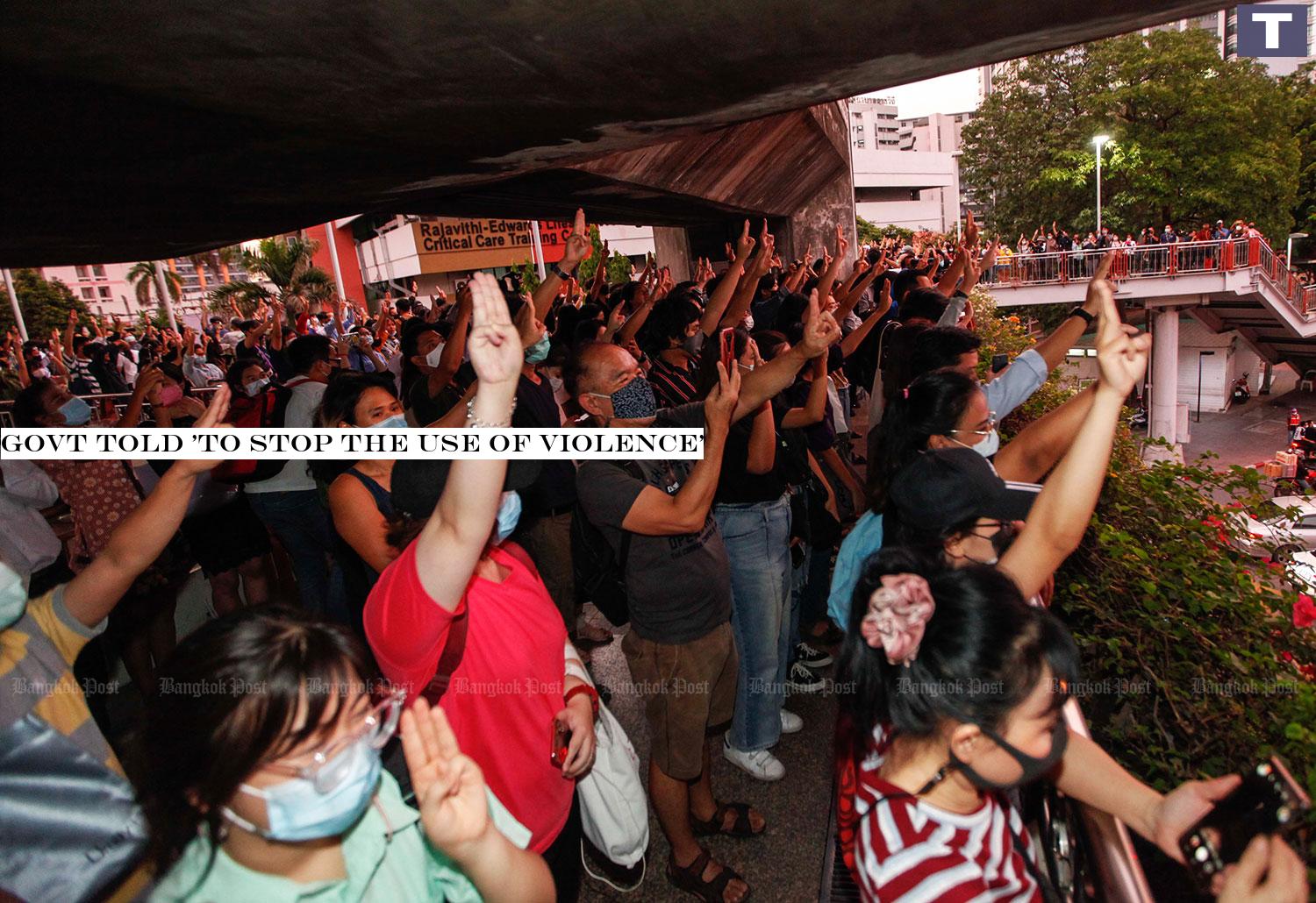 Protesters flash a three-finger salute at a gathering near Victory Monument. (Photo by Pattarapong Chatpattarasill) Govt told 'to stop the use of violence'