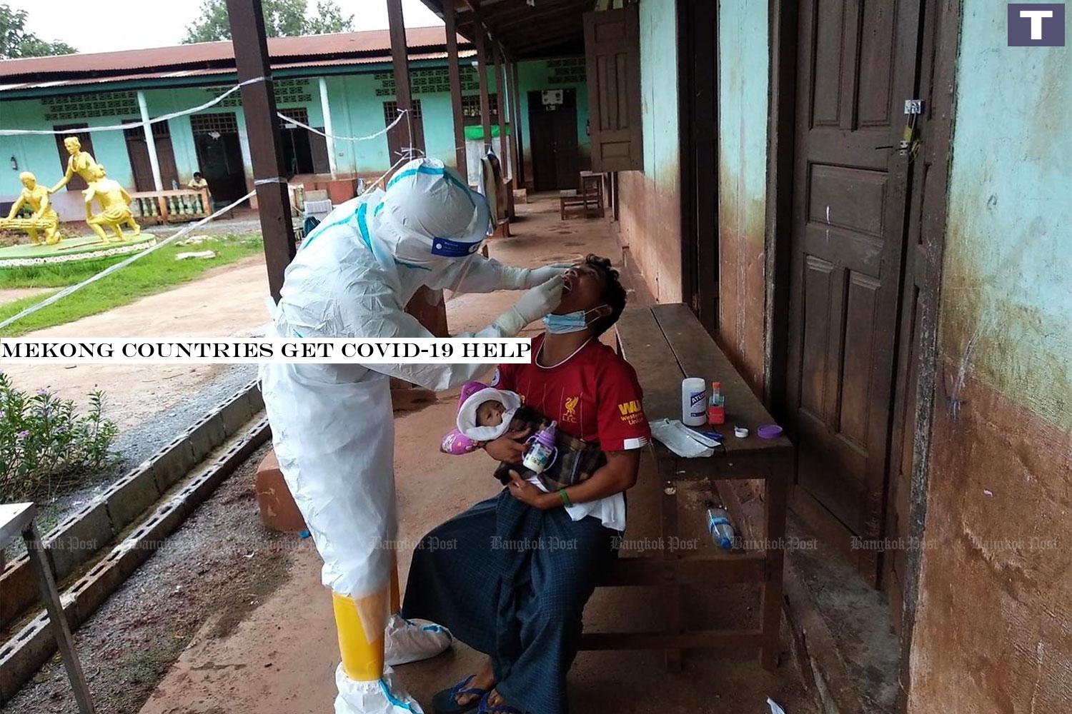 Myanmar's Payathonzu's rescue team swab the throat of a Myanmar man at an elementary school on the Myanmar-Thai border, 600 metres away from Thailand's Chedi Sam Ong border checkpoint in Kanchanaburi.â-#128;-#137;(Photo by Piyarach Chongcharoen) Mekong countries get Covid-19 help