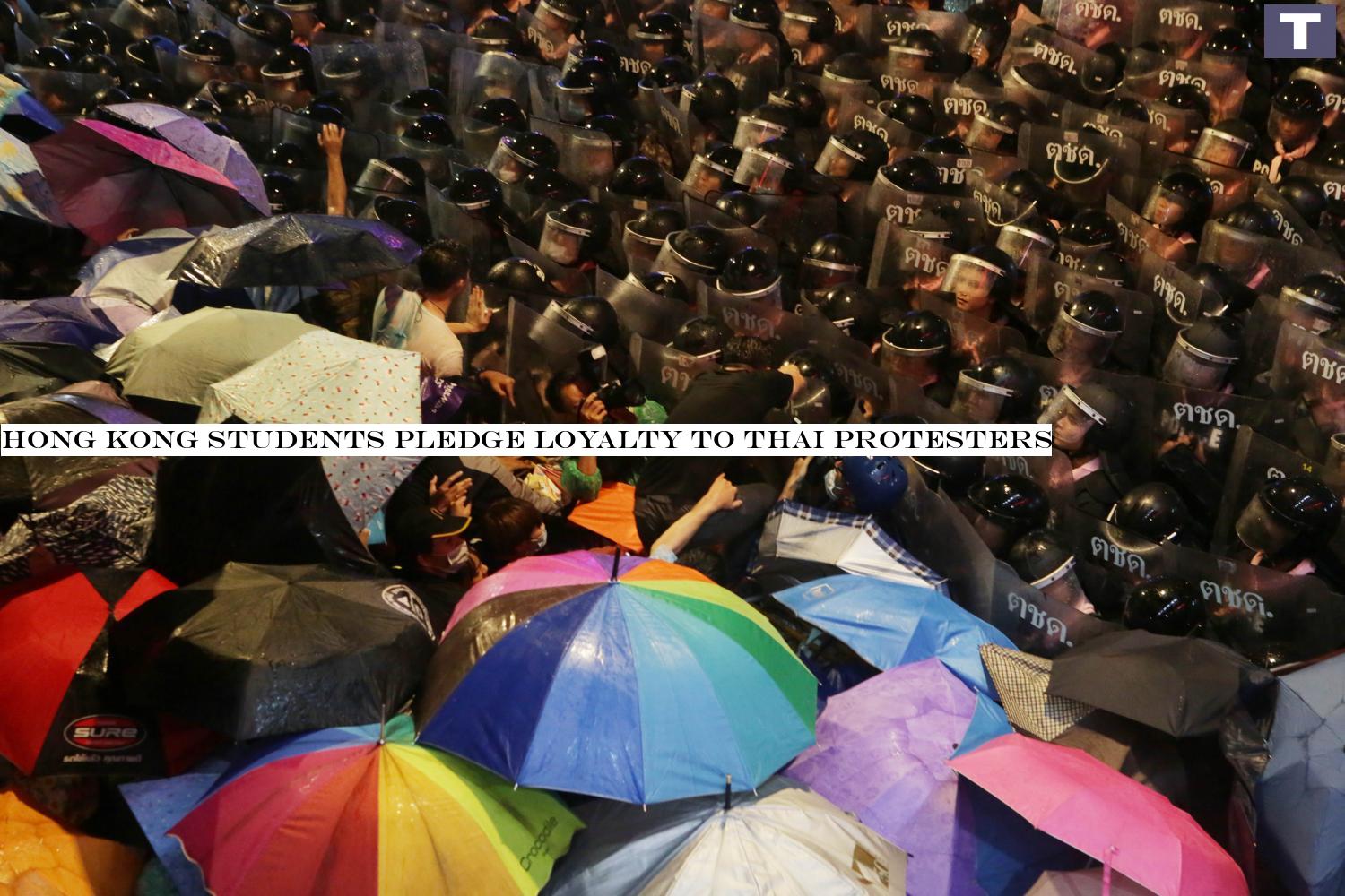 PUSH AND SHOVE: Police and protesters clash before a water cannon was deployed to disperse the crowd near Pathumwan intersection on Oct 16. Hong Kong students pledge loyalty to Thai protesters