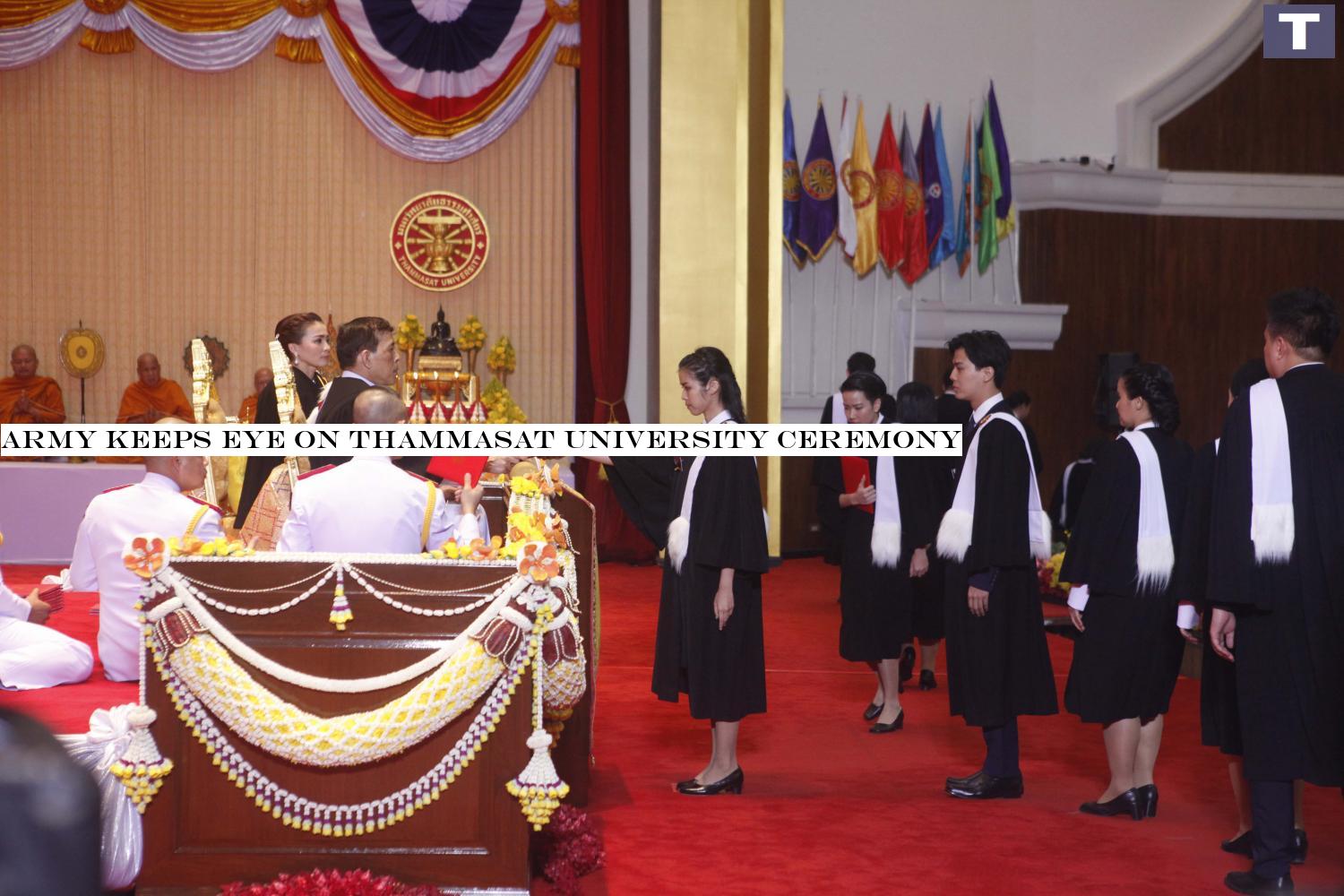 His Majesty the King, accompanied by Her Majesty the Queen, bestows diplomas to university graduates at Thammasat University's Tha Prachan campus on the first day of the graduation ceremony on Friday. (Photo by Pattarapong Chatpattarasill) Army keeps eye on Thammasat University ceremony