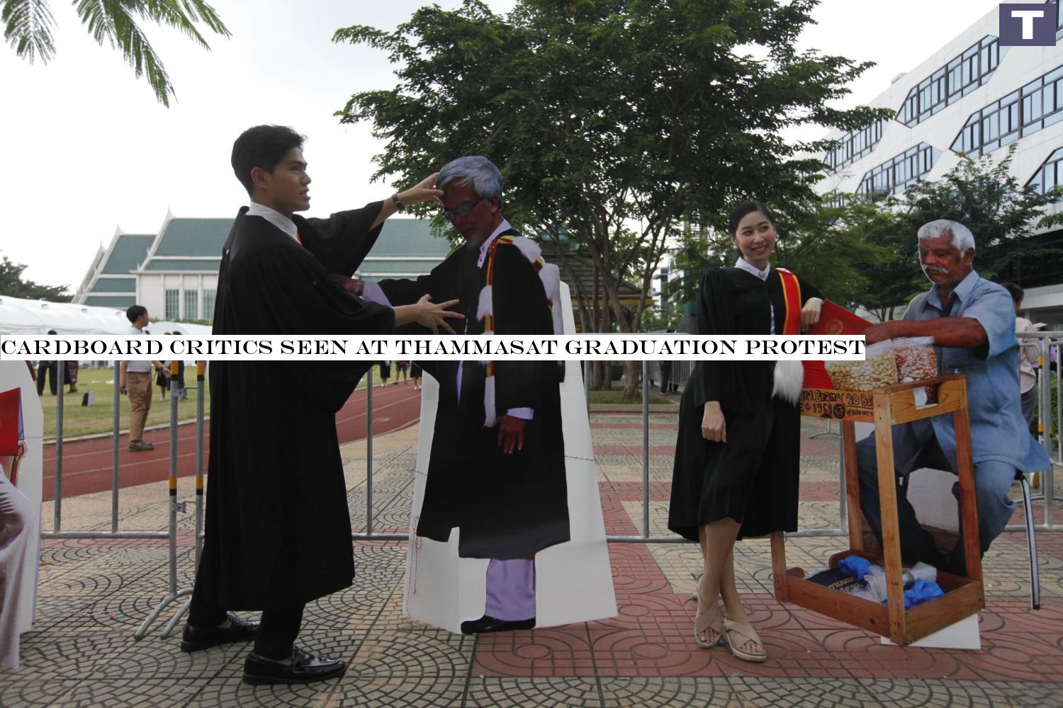 cut out for the job: Thammasat University graduates take photos with the cardboard cutout of exiled academic Somsak Jeamteerasakul and Bernard, a bean seller at the university's Tha Prachan campus. Cardboard critics seen at Thammasat graduation protest