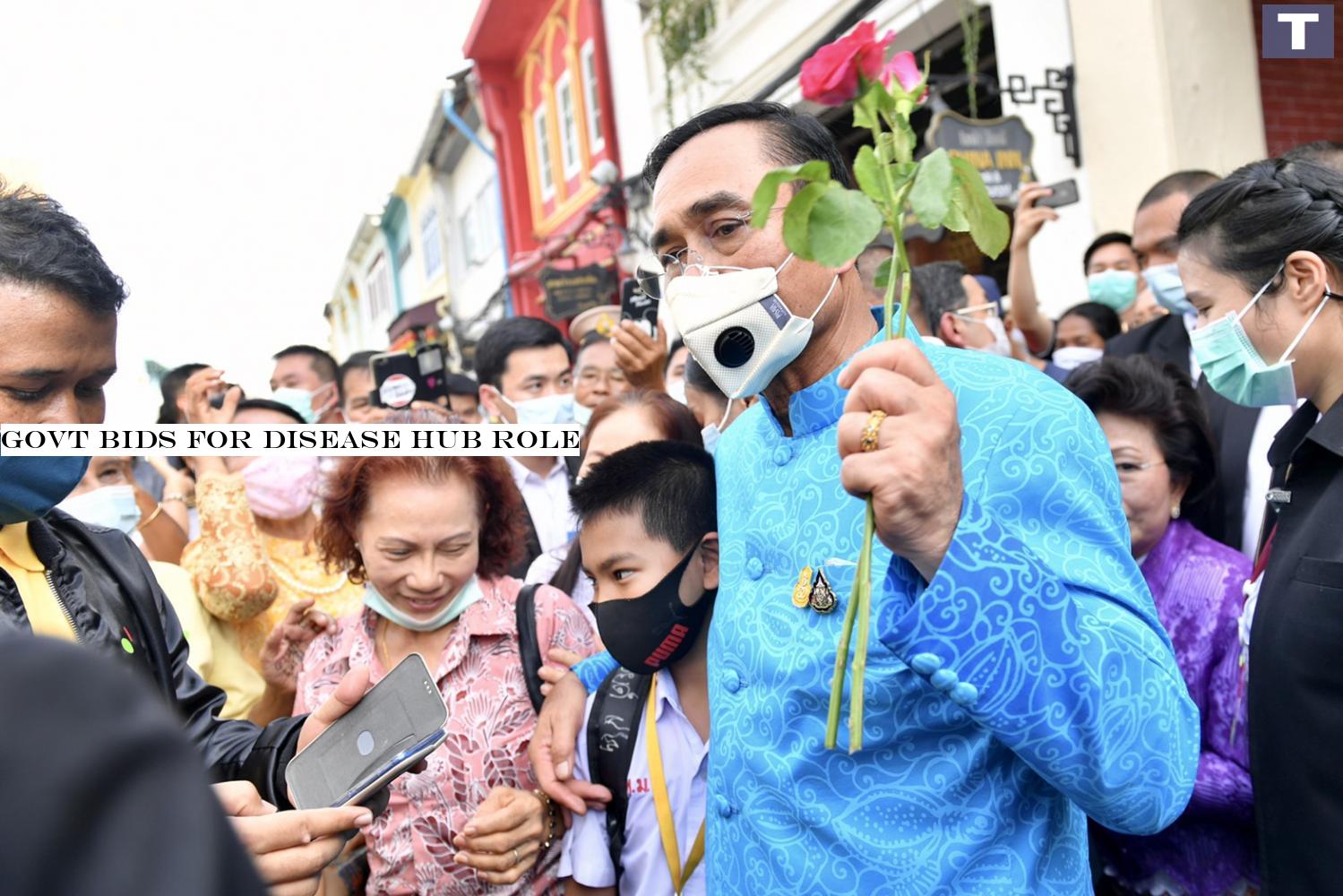 Prime Minister Prayut Chan-o-cha is welcomed by supporters during his walk in the old town of Phuket on Tuesday. (Government House photo) Govt bids for disease hub role