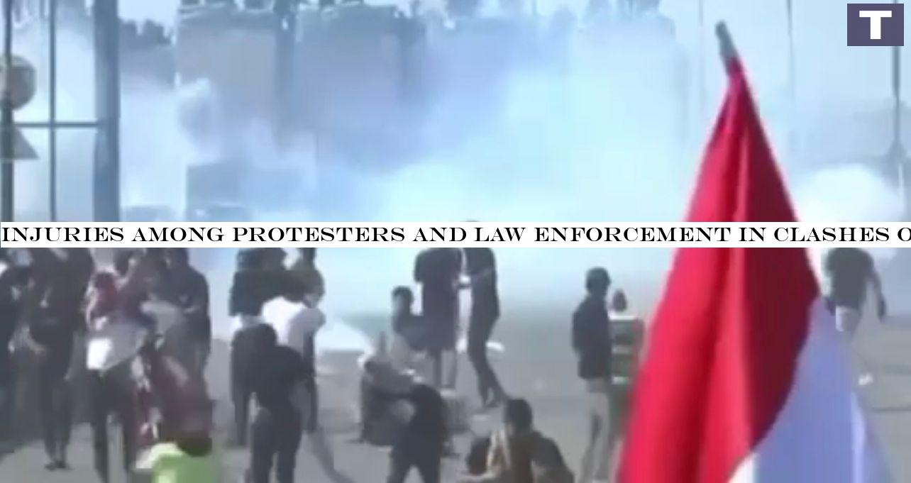 Injuries among protesters and law enforcement in clashes on a bridge leading to the Green Zone